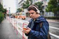 Man in headphones looking at smartphone